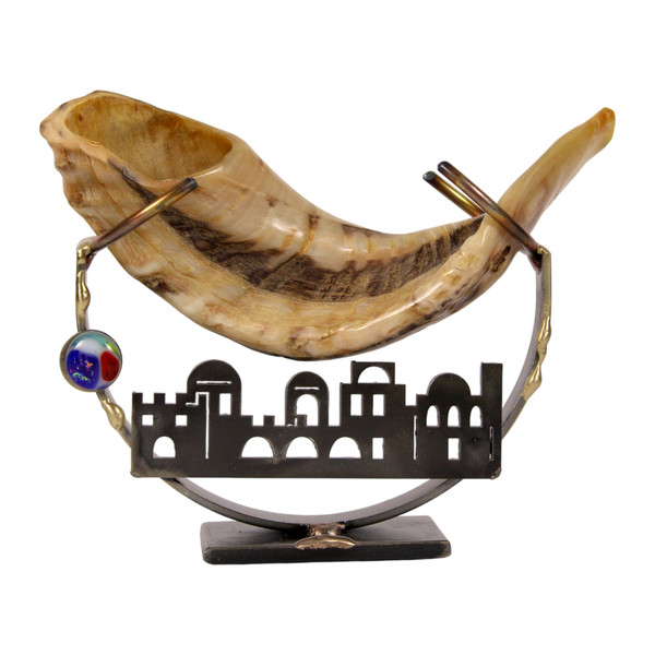 Shofar prepared for Rosh Hashanah beside apples and honey