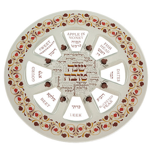 Rosh Hashanah simanim plate with apples honey pomegranate dates and symbolic foods