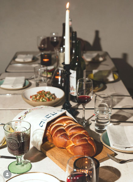Festive Shabbat meal table prepared with traditional foods